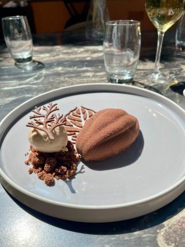 a white plate with two desserts on a table at Aquabella Hôtel & Spa in Aix-en-Provence