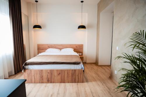 a bedroom with a bed with two pillows at At George`s Stay&Fly in Otopeni