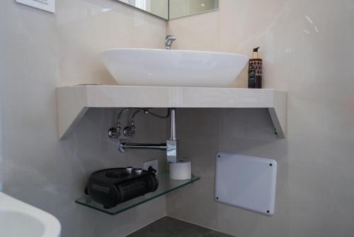 a bathroom with a white sink and a mirror at Relais Villa Ottavia in Bitonto