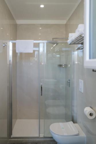 a bathroom with a glass shower with a toilet at Relais Villa Ottavia in Bitonto