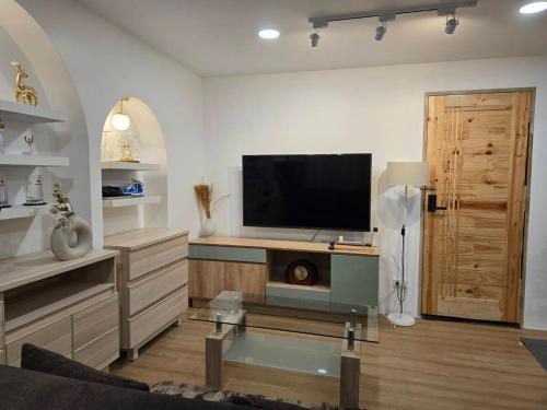 a living room with a flat screen tv on a wall at 103 Condominium 2, 2 bedroom in Chiang Mai