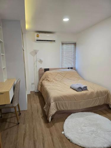 a bedroom with a bed and a desk and a chair at 103 Condominium 2, 2 bedroom in Chiang Mai