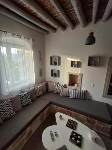 a living room with a couch and a table at Traditional house in the heart of Naxos in Dhamariónas