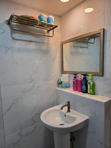 a bathroom with a sink and a mirror at 103 Condominium 2, 2 bedroom in Chiang Mai