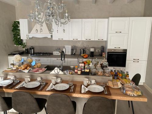 a kitchen with a table with food on it at B&B Civico 69 Esclusivo in Franciacorta in Capriolo
