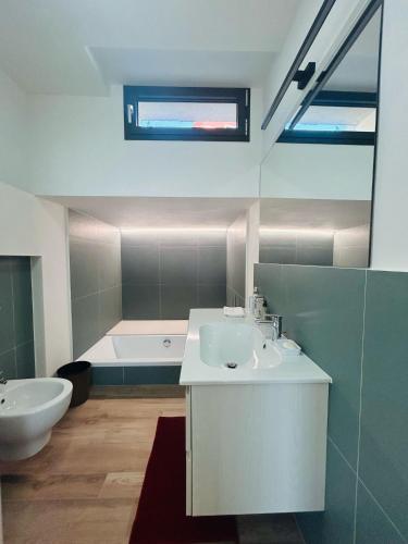 a bathroom with a sink and a bath tub at La casa dell'orto in Imperia