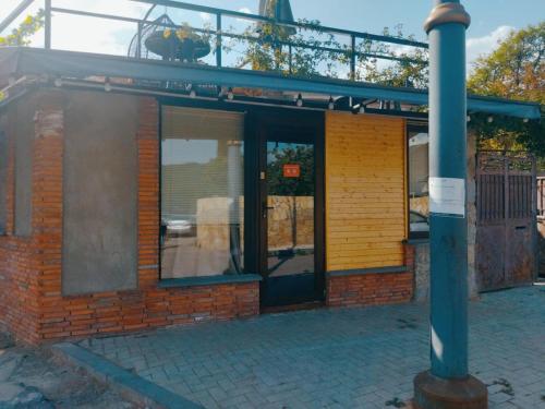 a brick building with a pole in front of it at Old Capital in Mtskheta