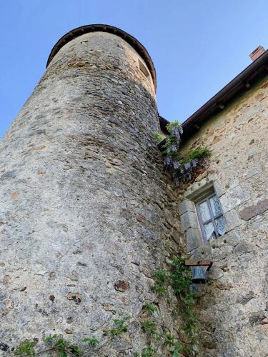 a tall brick building with a window on it at Chateau Mareuil in Brigueuil-le-Chantre