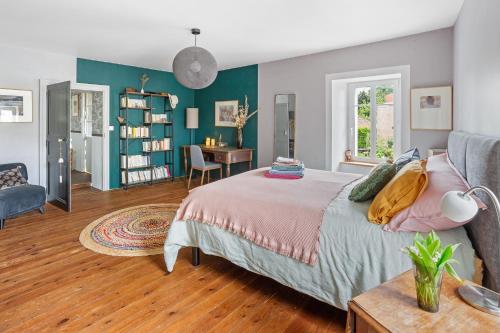 a bedroom with a bed and a desk and a chair at La Petite Fouques - Confortable et paisible in Cugand