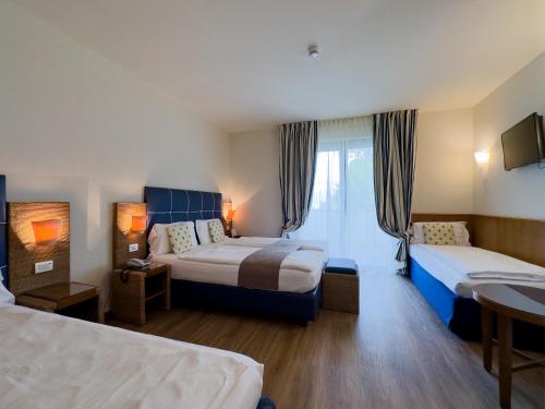 Ένα ή περισσότερα κρεβάτια σε δωμάτιο στο Hotel Arena