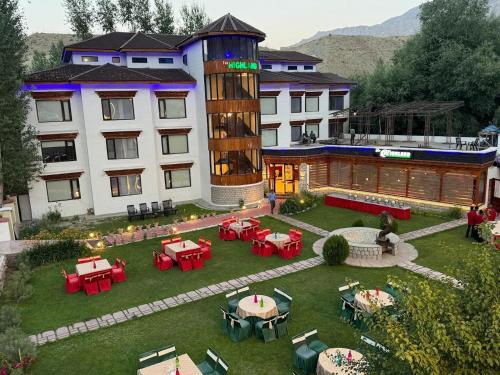 an aerial view of a hotel with tables and chairs at The Highland Mountain Resort & Spa Kargil in Kargil