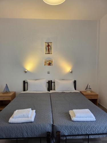 a bedroom with a bed with two towels on it at Calypso Heaven in Santorini