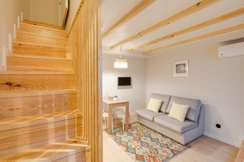 a living room with a couch and a table at Figueirôa Four Houses by DA'Home in Porto