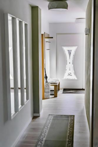 a hallway with green and white walls and a rug at Fewo Waldfeeling in Brilon