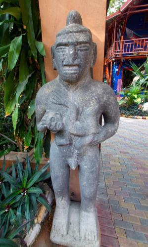 a statue of a person standing on a sidewalk at Tico Adventure Lodge in Sámara
