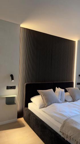 a bedroom with a large bed with white pillows at Hotel Weinhaus Kreuter in Koblenz