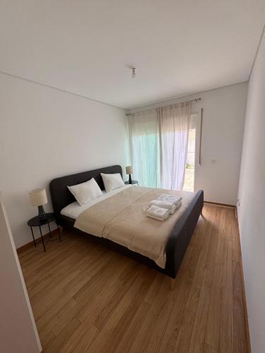 Ένα ή περισσότερα κρεβάτια σε δωμάτιο στο Ninho da Praia Costa Nova