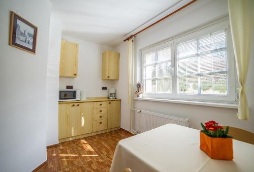 a kitchen with a table and a window at Pension Jana in Český Krumlov