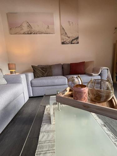 a living room with a couch and a table at Charming Penthouse in Lauterbrunnen