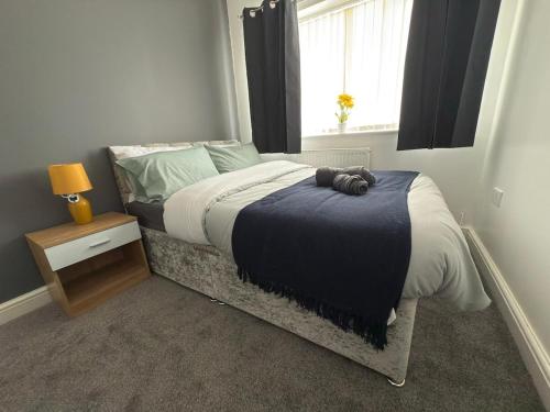 a bedroom with a bed with a teddy bear on it at Sunderland Castle Free Parking in Sunderland