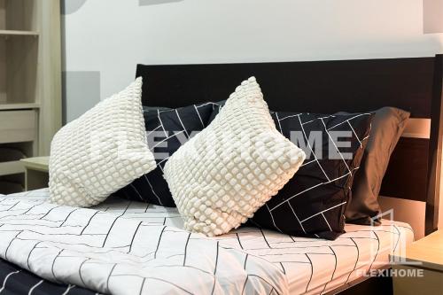 a bed with four pillows on top of it at 10am-6pm, SAME DAY CHECK IN AND CHECK OUT, Work From Home, Shaftsbury-Cyberjaya, Comfy Home by Flexihome-MY in Cyberjaya