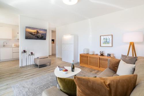 a living room with a couch and a table at Terrassenwohnung "Haffromantik" in Garz