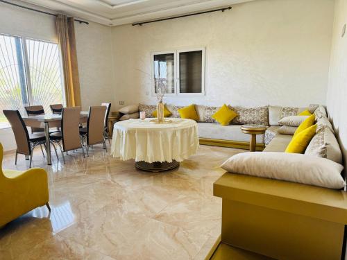 a living room with a couch and a table at Peaceful Pool Villa in Marrakech
