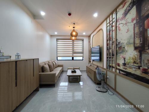 a living room with a couch and a table at Nhà Nắng Vàng in Hai Phong