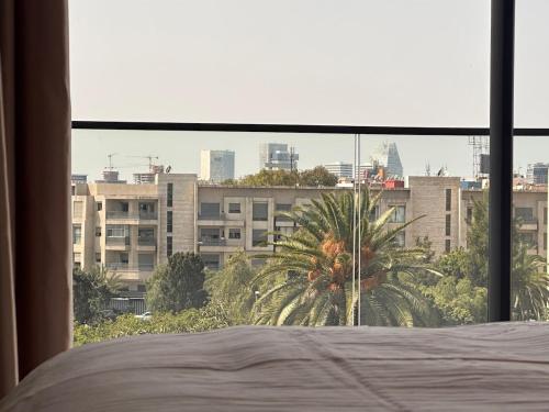 a bedroom with a bed and a view of a city at Chic & central in Maarif
