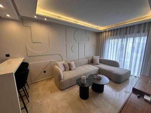 a living room with a couch and a table at Chic & central in Maarif