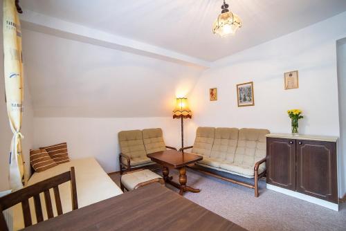 a living room with two chairs and a table at Pension Jana in Český Krumlov