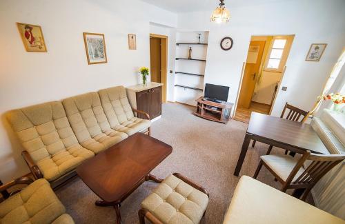 a living room with a couch and a table at Pension Jana in Český Krumlov