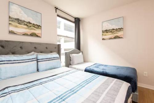 a bedroom with two beds and a window at Downtown Los Angeles Gem 2 in Los Angeles