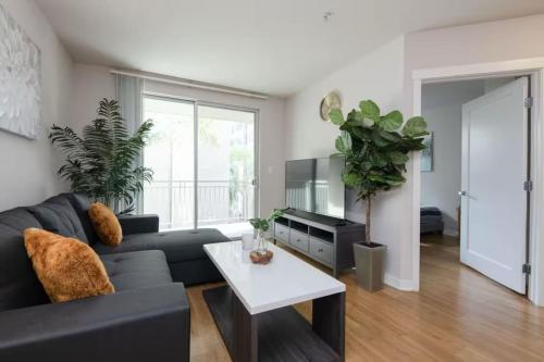 a living room with a black couch and a table at Downtown Los Angeles Gem 2 in Los Angeles