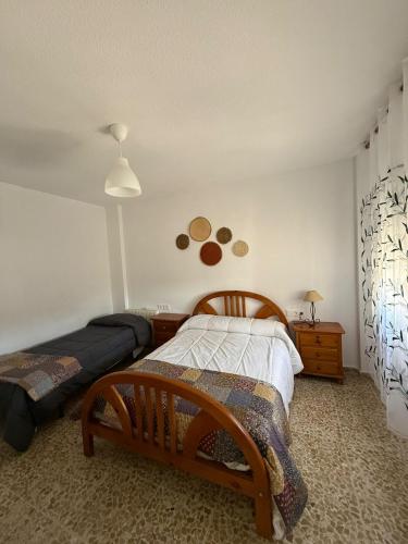 a bedroom with a bed and a nightstand and a bed sidx sidx sidx sidx at Casa rural con piscina privada en Nívar, vistas espectaculares a 15 min de Granada in Nívar