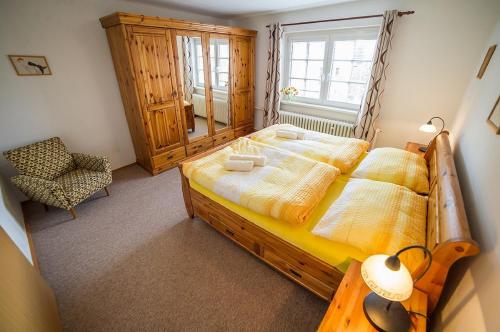 a bedroom with a large bed and a window at Pension Jana in Český Krumlov