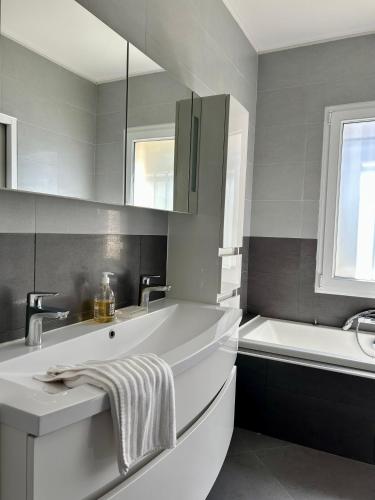 une salle de bain avec une baignoire et un lavabo et une baignoire dans l'établissement Villa ALFALINE, à Port Grimaud