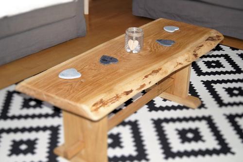 a wooden coffee table with a glass on top of a rug at Apartment Lungau in Sankt Michael im Lungau