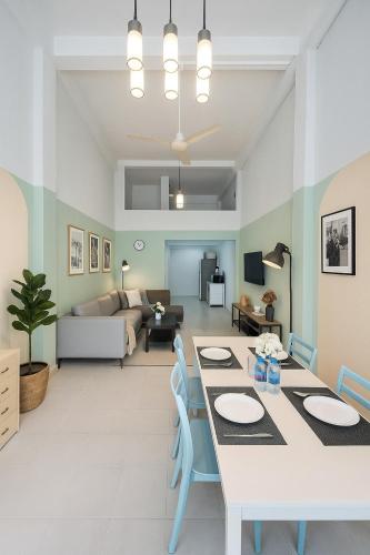 a dining room and living room with a table and chairs at GM5 - Cozy Apartment 8pax, Ladprao, MRT&BTS in Bangkok