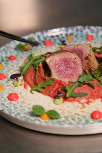 a plate of food with meat and vegetables on it at Doanesia Premium Hotel & Spa in Tirana