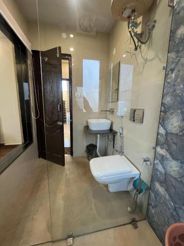 a bathroom with a sink and a toilet and a shower at Ambrosia Grand in Shimla