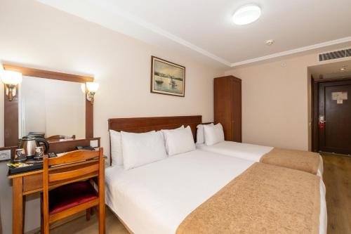 a hotel room with a bed and a desk at Askoc Hotel & SPA in Istanbul