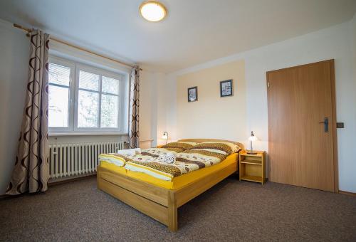 a bedroom with a bed and a window at Pension Jana in Český Krumlov