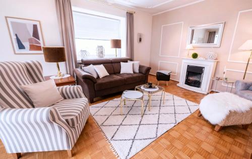 a living room with a couch and a fireplace at Haus Sonneneck 1 in Bad Zwischenahn
