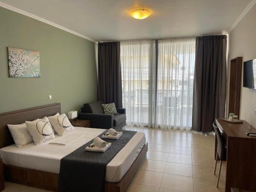 a hotel room with a bed and a desk at Centrum Rooms in Kallithea Halkidikis