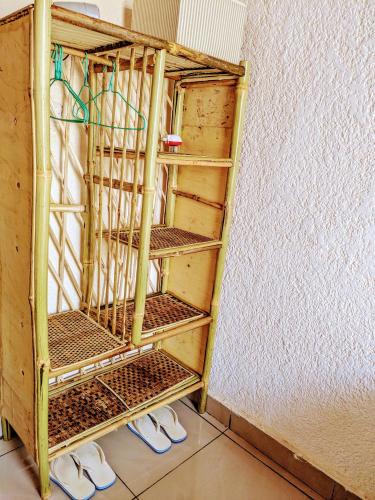 a pair of shoes are standing in a room at Randa's House I Homestay in Ruhengeri
