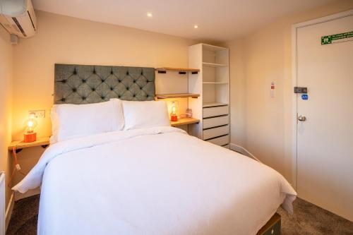 a bedroom with a large white bed and a closet at 82A Dalston Lane Terrace in London