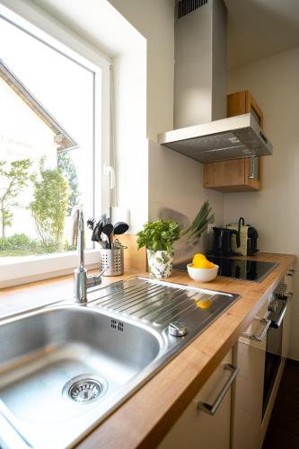 a kitchen with a sink and a window at Ferienwohnung Quehenberger in Millstatt
