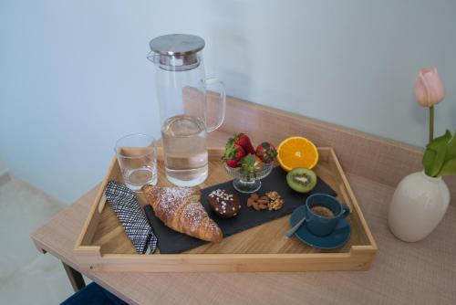 a tray with food and drinks on a table at Relais Villa Ottavia in Bitonto