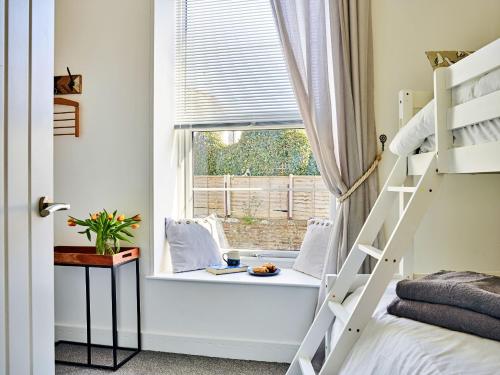 a bedroom with a window seat and a bunk bed at Finest Retreats - Riverview in Stratton